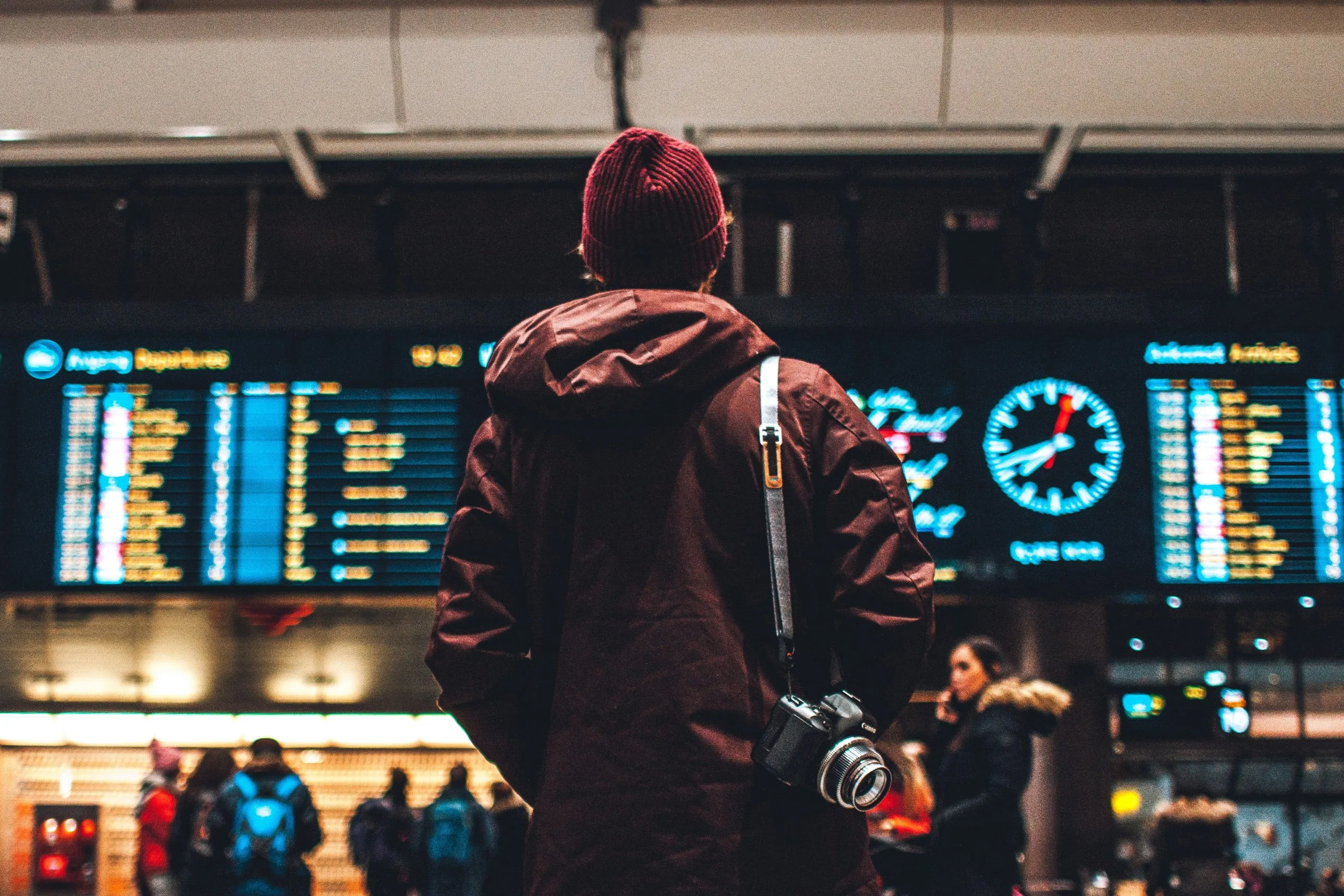Traveller looking at an airport departures board